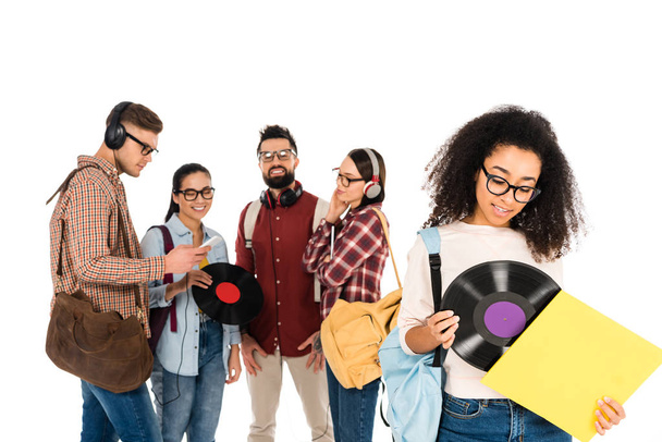 beautiful african american girl standing with vinyl record near milticultural group of people in glasses isolated on white - Photo, Image