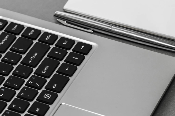 Closeup view of laptopkeyboard, planner and a pen. - Φωτογραφία, εικόνα