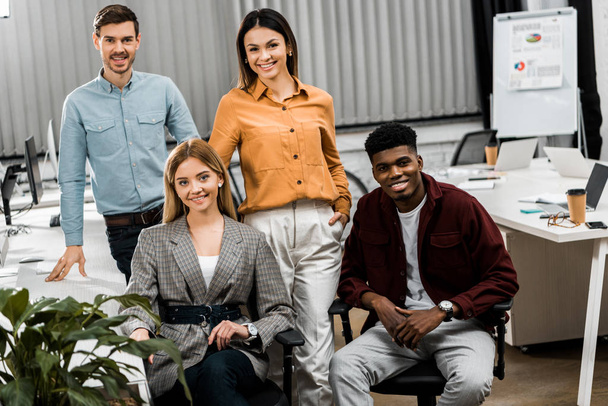 young smiling multiracial business colleagues looking at camera in office - Photo, Image
