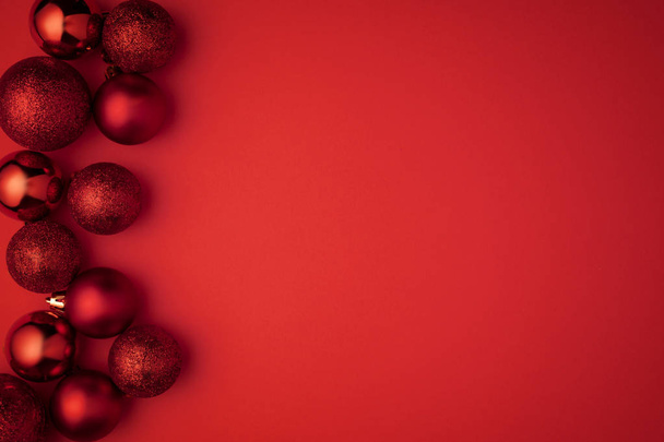 Christmas red ball on red background Flat lay. Christmas winter decoration. top view. copy space - Photo, image