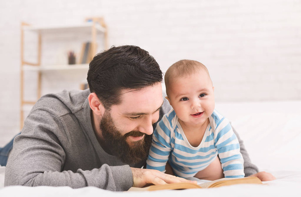 Padre leyendo libro a pequeño hijo bebé
 - Foto, Imagen