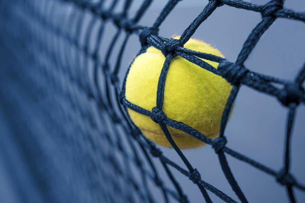 Tennis ball in the net - Foto, Imagen