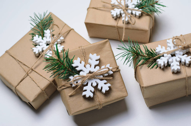 Christmas Gifts with Fir Branches and Wooden Snowflakes on White Background, Winter Holidays Concept - Valokuva, kuva
