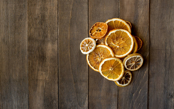 slice of orange and lemon dried agrumes on icing sugar wooden table - Фото, изображение