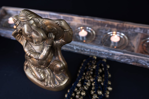 Rustykalne, Indian obiekty związane z performing arts - Ganesha, świeczki, koraliki, naszyjniki i biżuteria - na teksturowanej tło. - Zdjęcie, obraz