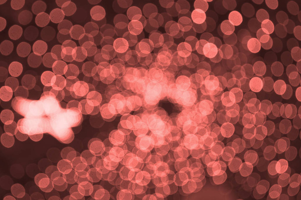Abstracte wazig levend koraal kleur achtergrond met kleine lampjes. Party concept. - Foto, afbeelding