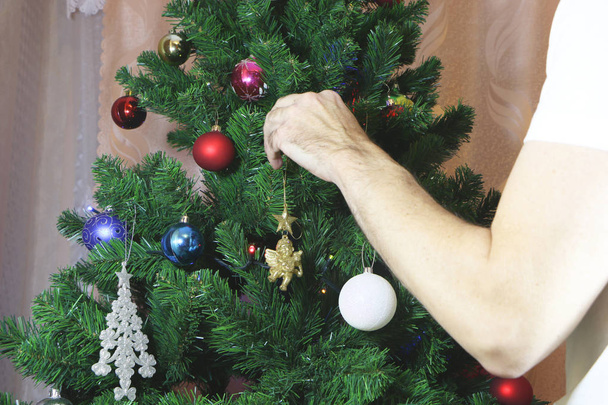 parents dress up a Christmas tree or a New Year tree for children - Foto, Imagem