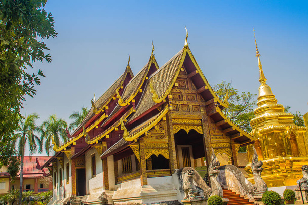 Lanna style Buddhist church at Wat Phra Singh(Temple of the Lion Buddha) with blue sky background. Wat Phra Singh is an important Buddhist monastery and temple on the west side of Chiang Mai, Thailand - Foto, immagini