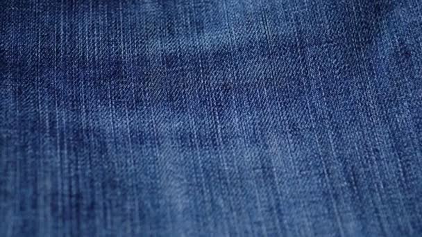 Blue denim jeans texture. Jeans background. Top view. - Πλάνα, βίντεο