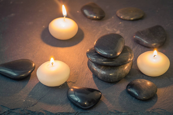 black stones and burning candles on dark background - Photo, Image