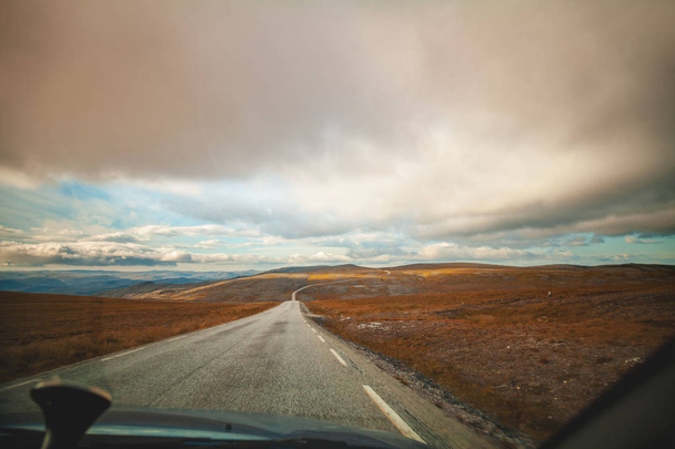 Driving a car on a mountain road. Nature of north Norway. Polar circle. The road to Nordkapp - Фото, зображення