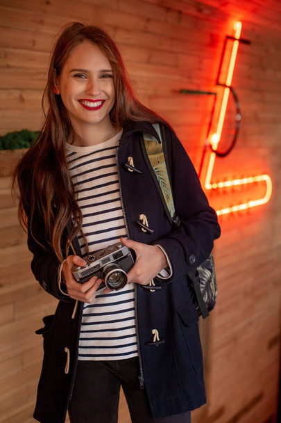 Happy young hipster woman holds retro photo camera - Φωτογραφία, εικόνα