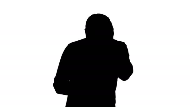 Silhouette Stressed young man shocked surprised, horrified and disturbed, by what he sees on his cell phone. - Footage, Video