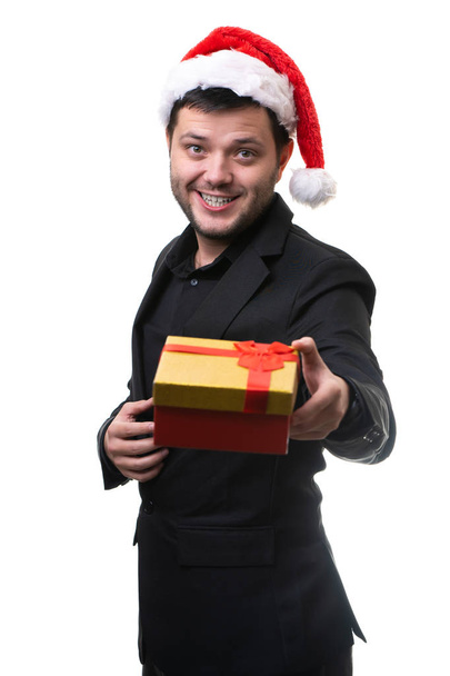 Photo of man in Santa hat with gift in his hands - Foto, imagen