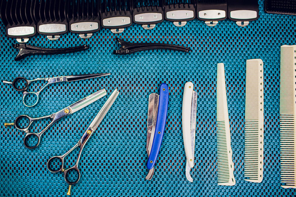 Close up cropped photo accessories barber shop stylist. He is organizing them in order his work place - 写真・画像