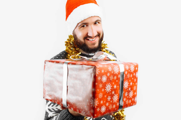 ein Mann mit einem Weihnachtsgeschenk in der Hand - Foto, Bild