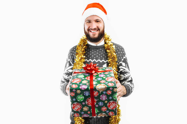 A man with a Christmas gift in his hands - Foto, afbeelding