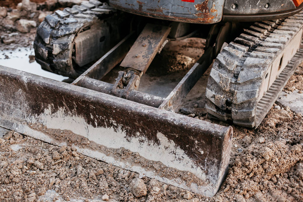 Close up of bulldozer working with soil on construction site - Zdjęcie, obraz