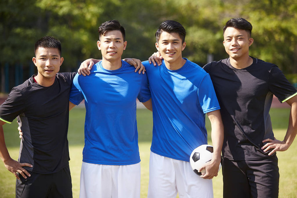 outdoor portrait of a team of young asian soccer football players - Photo, Image