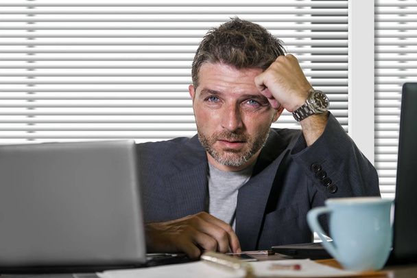 young attractive upset and stressed businessman working overwhelmed suffering stress at office computer desk in corporate business job problem feeling anxiety crisis looking worried - Foto, Bild