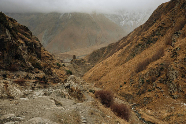 Mountain range on a hiking trail from Stepantsminda to Gergeti Trinity Church. a famous landscape in Kazbegi, Mtskheta-Mtianeti, Georgia. - Foto, Imagem