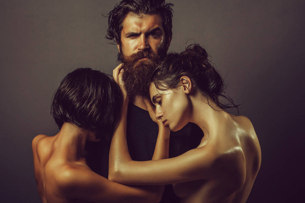 Bearded man and naked women - Фото, изображение