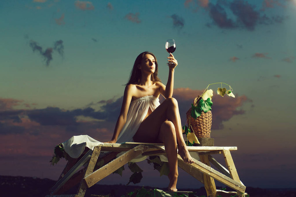 pretty woman with wine over sky - Φωτογραφία, εικόνα