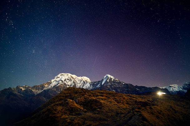 Snowy Annapurna and Hinchuli mountains at night starry sky in Nepal  - Photo, image