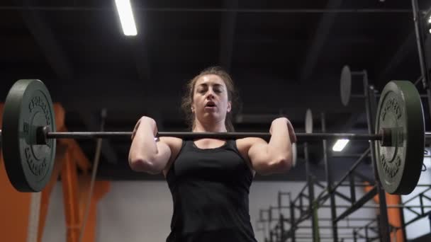 Fitness-Frau beim Langhantel-Liegestütztraining im Fitnessstudio - Filmmaterial, Video