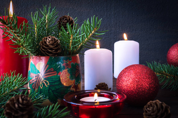 Burning candles with festive decorations and pine cones - Fotografie, Obrázek