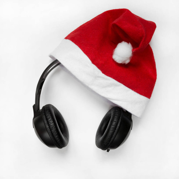 Santa hat with headphones on white background - Photo, Image