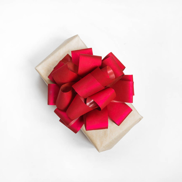 Gift box in festive packaging on white background - Fotó, kép