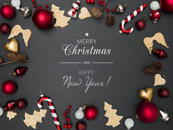 christmas background with lettering merry christmas and happy New year and frame of red baubles and gingerbread cookies  - 写真・画像