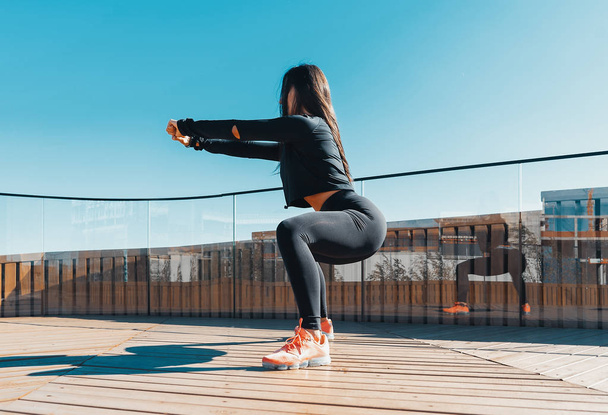 Fitness woman stretching and exercising outdoors in urban environment. - Φωτογραφία, εικόνα