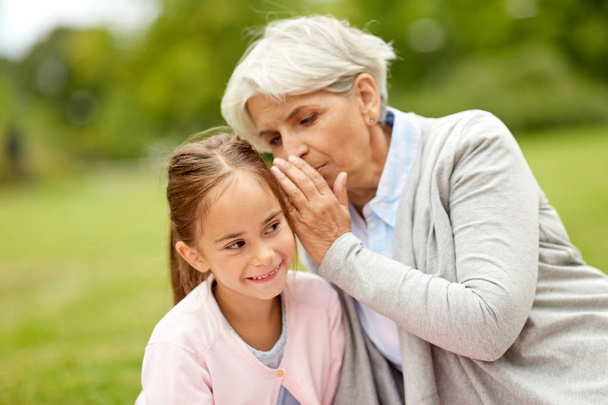 granddaughter sharing secrets with grandmother - Foto, imagen