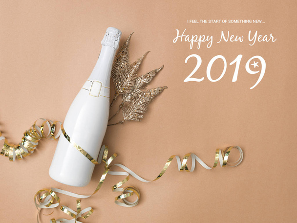 new year composition with bottle of champagne and New Year Eve items on bronze background  - Photo, image