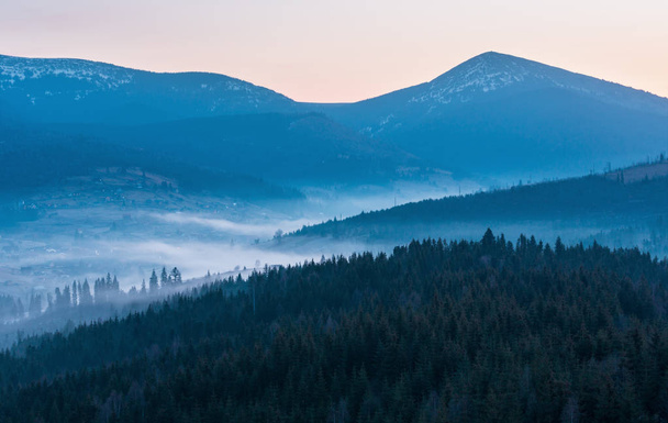 Early morning spring Carpathian mountains plateau landscape with snow-covered ridge tops in far, Ukraine. - Foto, Imagem