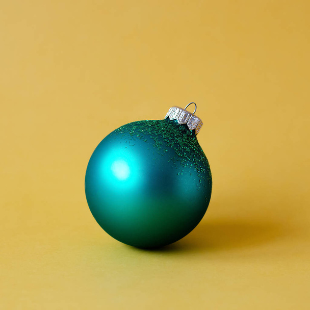 Зеленый шар игрушка на елке на оранжевом фоне
. - Фото, изображение