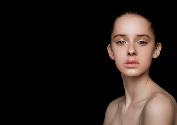 Beauty cute fashion model with natural make up on black background - 写真・画像