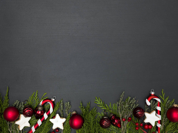 christmas grey background with collection of red Christmas items and cookies on fir branches  - Foto, imagen