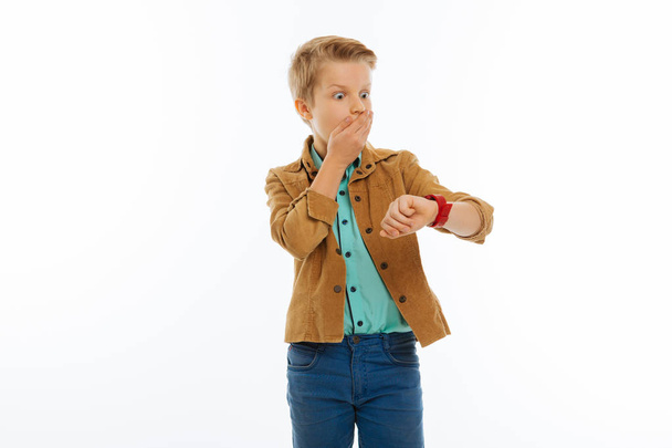 Nice surprised young boy covering his mouth - 写真・画像