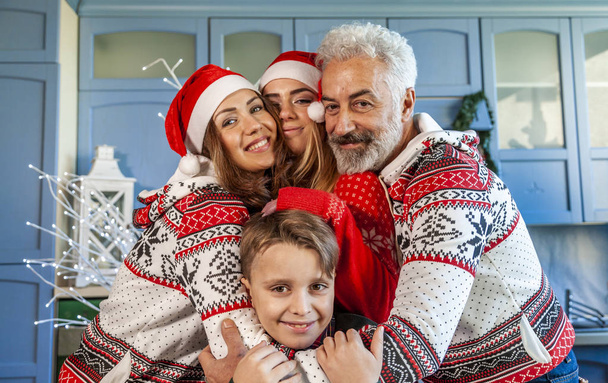 happy family reunited on christmas day hugging each other at home - Fotografie, Obrázek