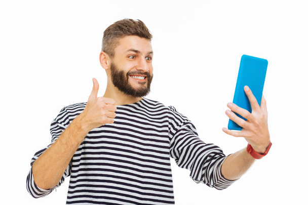 Happy bearded man taking a selfie on the tablet - Photo, Image
