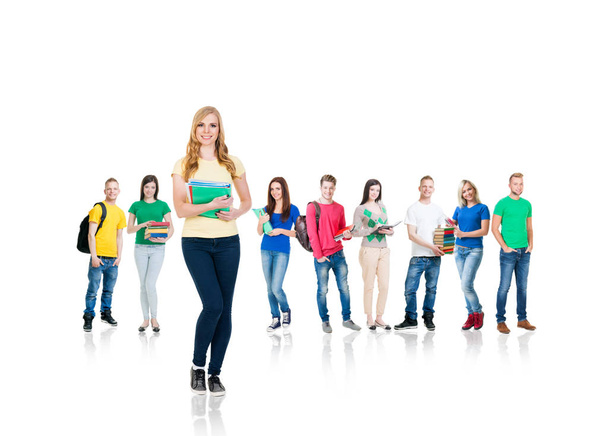 Large group of smiling friends staying together and looking at camera isolated on white background. Friendship and education concept. - Valokuva, kuva