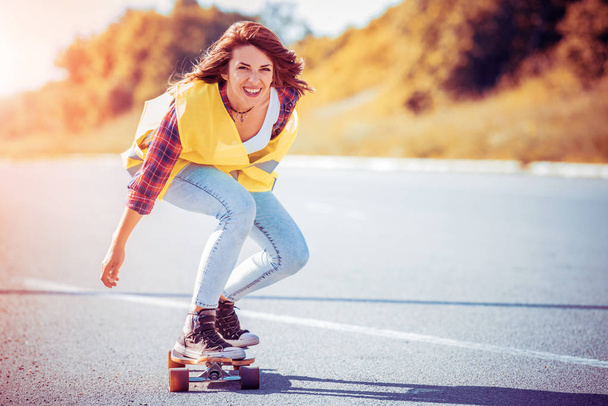 Young woman having fun on a longboard. - Fotó, kép