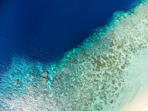 Aerial top down view coral reef tropical caribbean sea, turquoise blue water. Indonesia Moluccas archipelago, Banda Islands, Pulau Hatta. Top travel tourist destination, best diving snorkeling. - Photo, Image