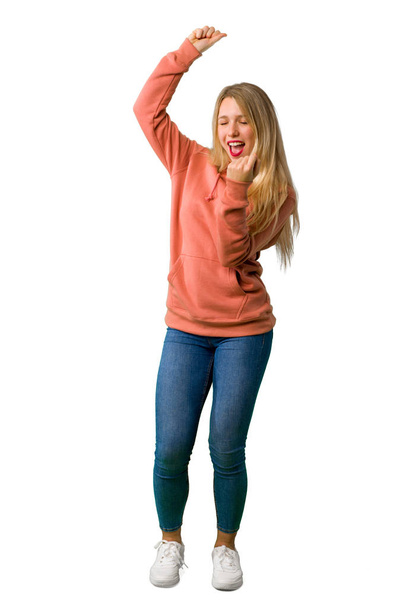 A full-length shot of a Young girl celebrating a victory on isolated white background - Valokuva, kuva