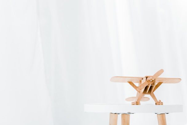 wooden plane model on white table at home - Foto, imagen