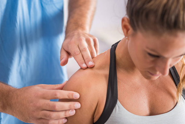 Physical therapy. Therapist addressing trapezius muscle - Fotoğraf, Görsel