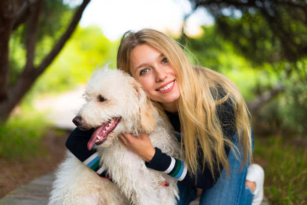 Young girl with her dog in a park - Foto, Bild